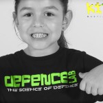 young girl showing off her defence lab t-shirt