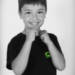 young boy in fighting stance and smiling
