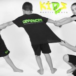 young girls pulling young boys arms